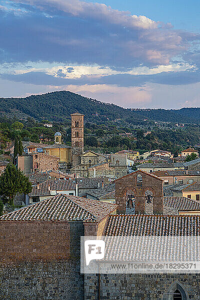 Italy  Lazio  Bolsena Italy  Lazio  Bolsena  Old town houses with bell tower and forested hill in background
