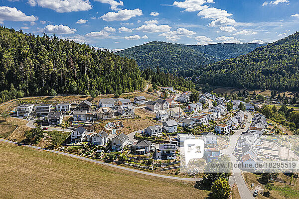 Germany  Baden-Wurttemberg  Bad Herrenalb  Aerial view of new modern development area with forested hills in background