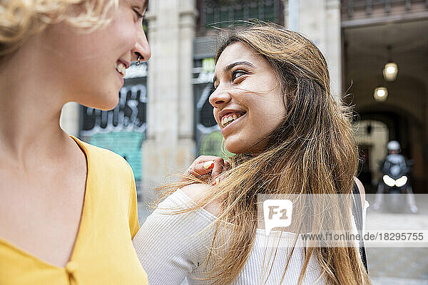 Smiling young woman spending leisure time with friend