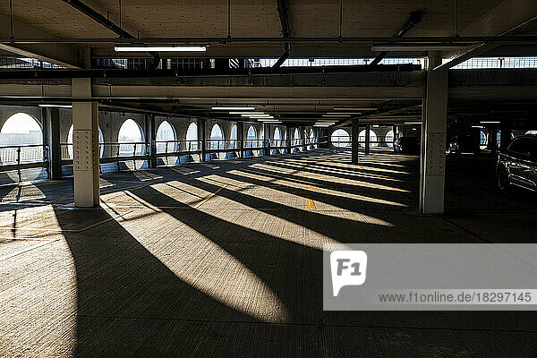 UK  England  Manchester  Arches casting shadows in empty multi storey parking lot
