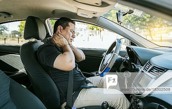 Exhausted driver with neck pain in traffic  Driver people with neck pain in car. Exhausted driver with pain and stress. Man in the car with neck pain