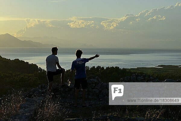 Two young men looking at Lake Scutari  also Lake Shkodra in the sunset  Shkodra  Shkoder  Albania  Europe