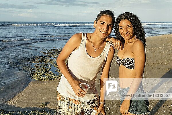 Two teenagers on the beach  Puerto Viejo  Limon  Caribbean  Costa Rica  Central America