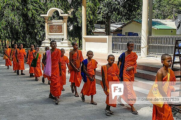 Buddhist child monks monastic students of faith religion of Buddha on the way to Buddhist temple  Ao Nang  Krabi province  Thailand  Asia