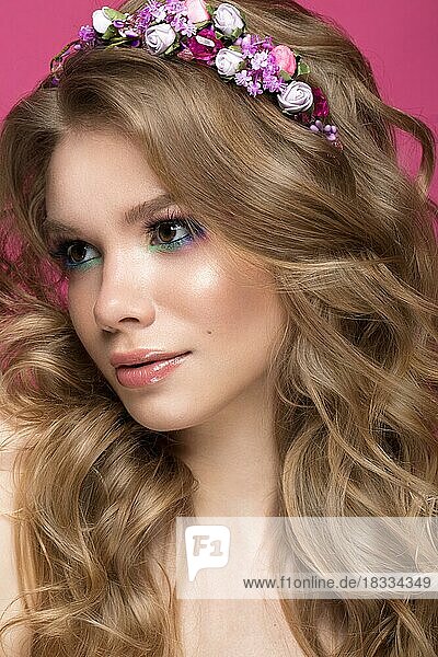 Portrait of a beautiful blond girl in image of the bride with purple flowers on her head. Beauty face. Photo shot in the Studio
