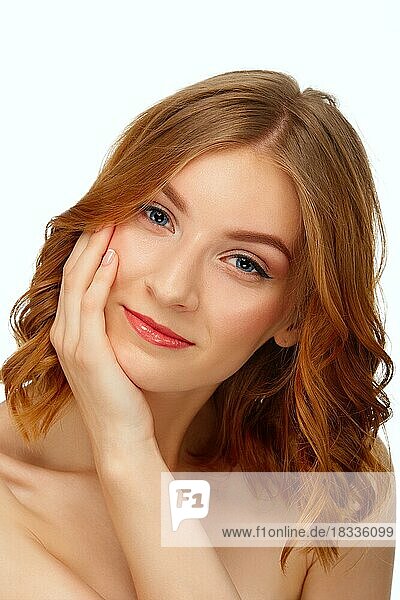 Beautiful young woman with blue eyes and red lips touching her cheek. Beauty portrait  fresh skin. Natural makeup