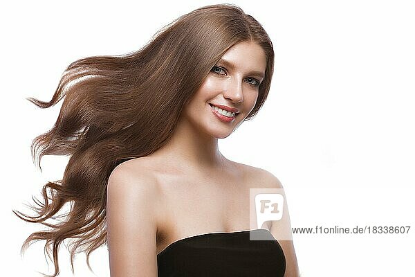 Beautiful brown-haired girl in move with a perfectly curls hair  and classic make-up. Beauty face and hair. Picture taken in the studio on a white background