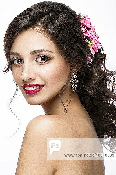 Portrait of a beautiful girl in image of the bride with purple flowers on her head. Beauty face. Photo shot in the Studio on a white background