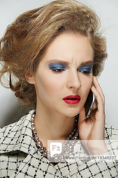 Closeup portrait of fashion model with retro style look  fluffy hair  red lipstick and green eyeshadow