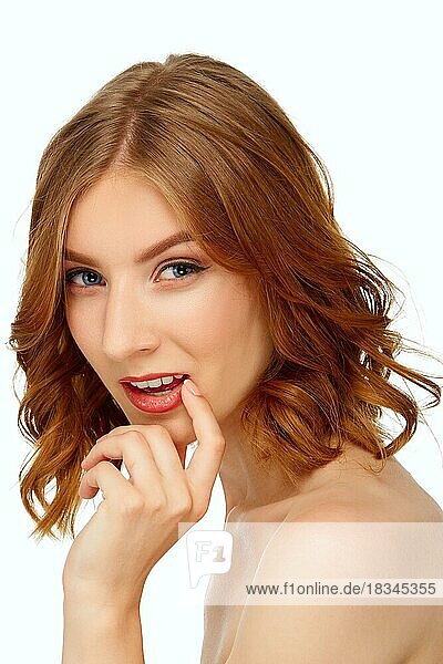 Beautiful young woman with blue eyes touching her lips. Beauty portrait  fresh skin. Natural makeup