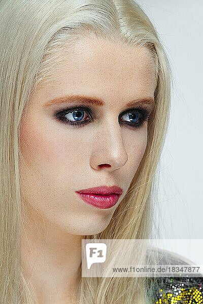 Girl with long straight white hair and defiant makeup  blue eyes and red lips