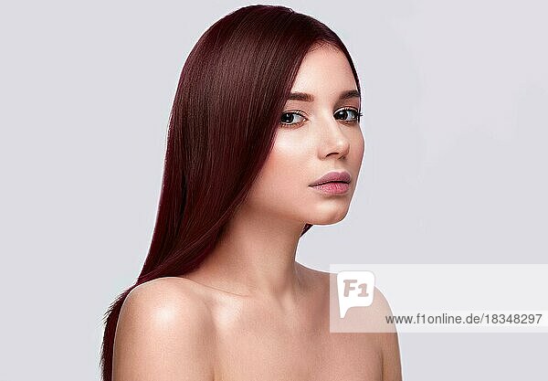 Portrait of beautiful brown-haired woman with a perfectly smooth hair  and classic make-up