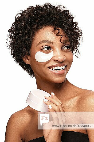 African American skincare models with perfect skin and curly hair with patches under her eyes  Beauty spa treatment concept