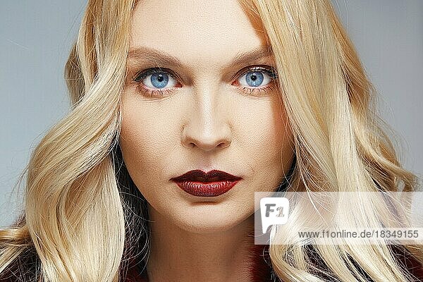 Close up portrait of beautiful fashion model. Clean fresh face of pretty girl with natural makeup  red lips and blue eyes