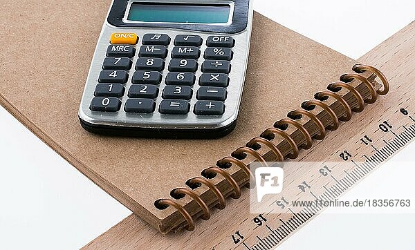 Calculator  ruler  notebook on white background