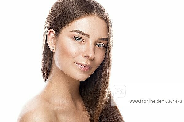 Beautiful young girl with a light natural make-up and perfect skin. Beauty face. Picture taken in the studio on a white background