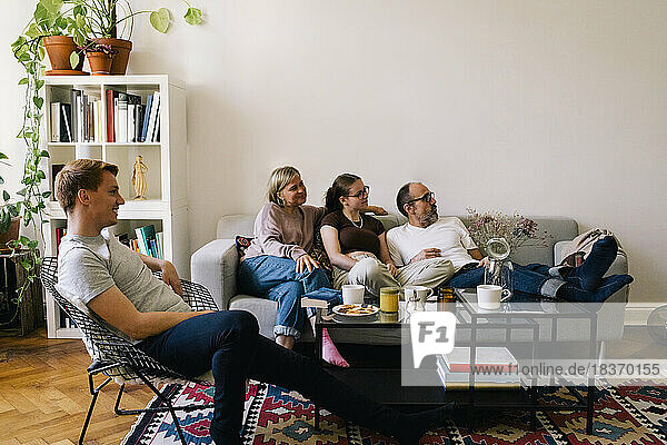 Family spending leisure time together watching movie in living room at home