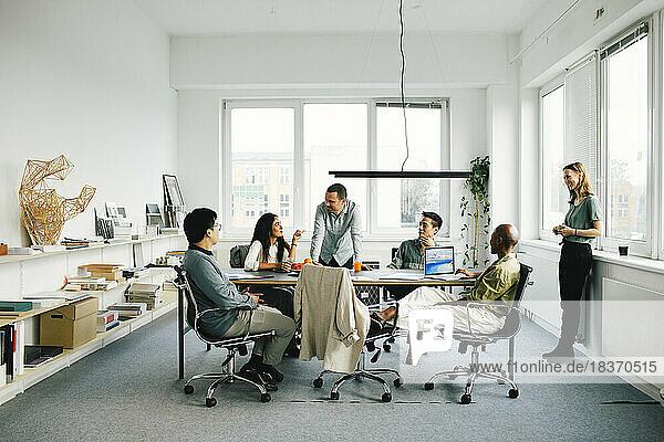 Multiracial business professionals discussing in meeting at office