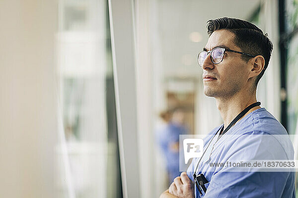 Mature male healthcare staff contemplating at hospital
