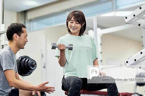 Japanese couple training at indoor gym