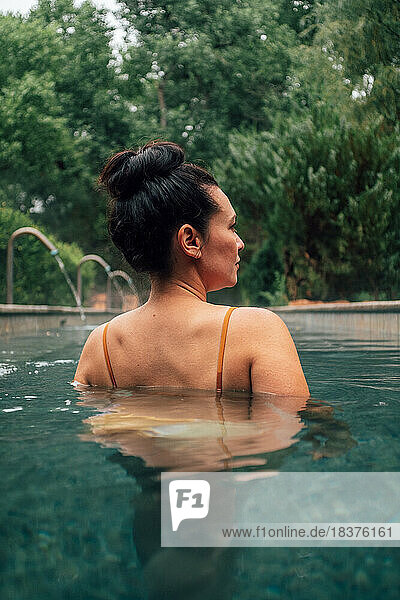 Woman in swimming pool in spa resort