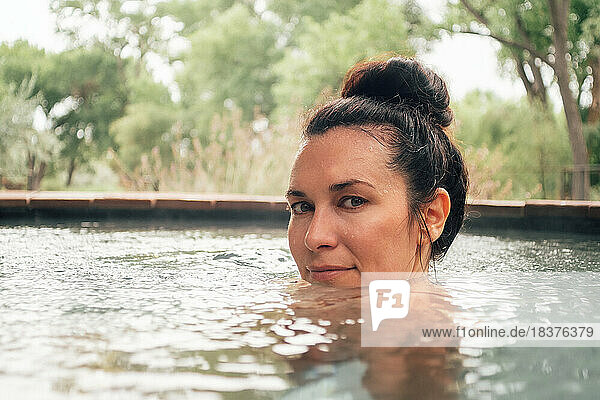 Portrait of woman in swimming pool in spa resort