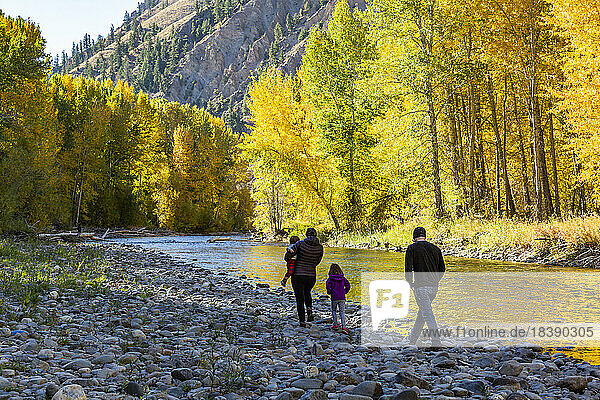 family admires fall along the Big Wood River near Sun Valley Idaho