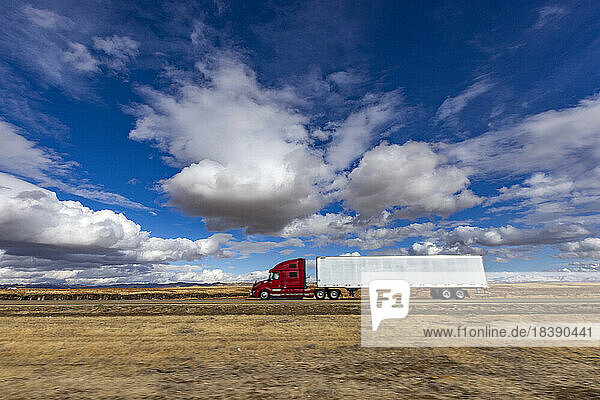 Semi truck travels in I 84 across Idaho
