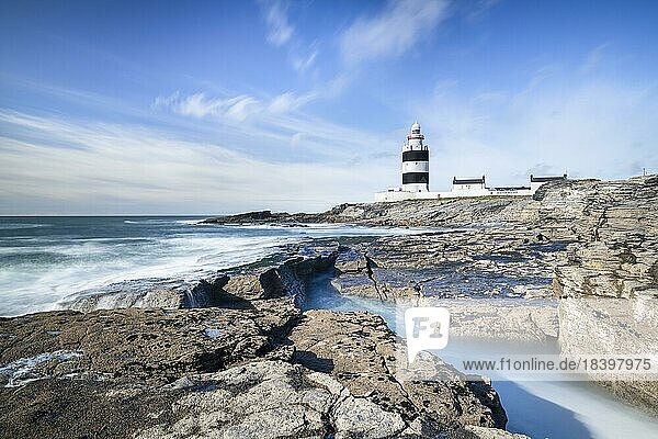 Hook Head lighthouse  blue sky and sea spray  Wexford  Ireland  Europe