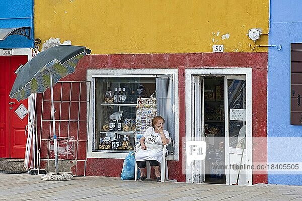 Ältere Ladenbesitzerin vor ihrem bunten Geschäft auf Burano  einer Insel in der Venezianischen Lagune in der Nähe von Venedig  Venetien  Norditalien