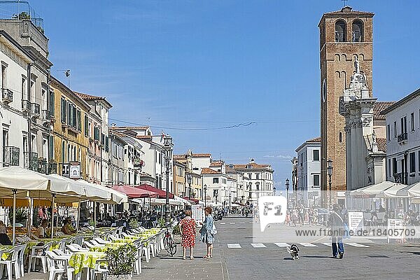 Bell tower and restaurants in the town Chioggia on small island at southern entrance to Venetian Lagoon near Venice  Veneto  Northern Italy