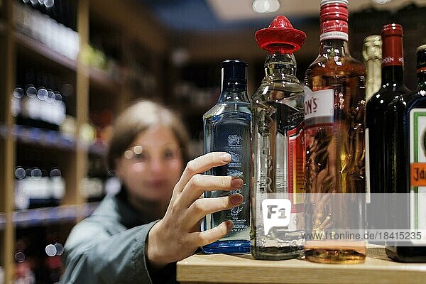 Young woman  student buys alcoholic drinks at the supermarket. Radevormwald  Germany  Europe
