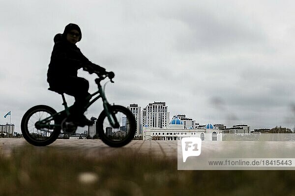 A child on a bicycle stands out in Astana  Astana  Kazakhstan  Asia