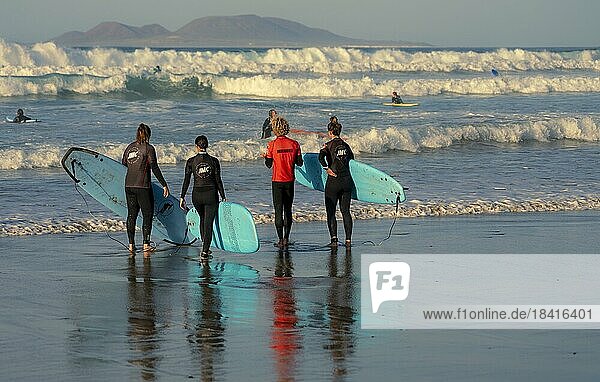 Surfers on the beach  Playa Famara  Lanzarote  Canary Islands  Spain  Europe