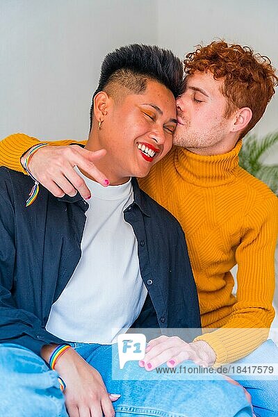 Portrait of beautiful gay couple making up and kissing  smiling indoors at home  lgbt concept
