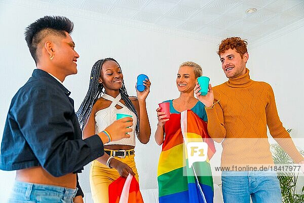 LGBT pride  lgbt rainbow flag  group of friends dancing and toasting with glasses in a house at party