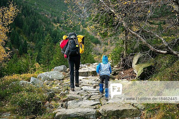 During the autumn  my mother and her little son go on a mountain trail. Polish mountains  Poland  Europe
