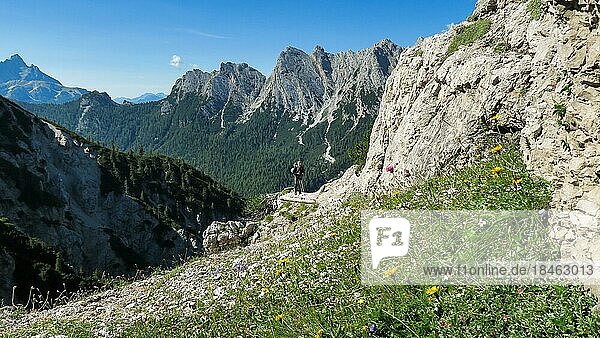 Tourist with equipment on a mountain trail in the Alps. Dolomites  Italy  Dolomites  Italy  Europe
