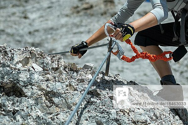 Climbing along a steel line on the via ferrata route in the dolomites. Dolomites  Italy  Dolomites  Italy  Europe