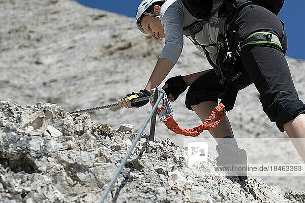 Climbing along a steel line on the via ferrata route in the dolomites. Dolomites  Italy  Dolomites  Italy  Europe