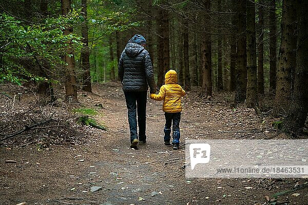 During the autumn  my mother and her little son go on a mountain trail.  Poland  Europe