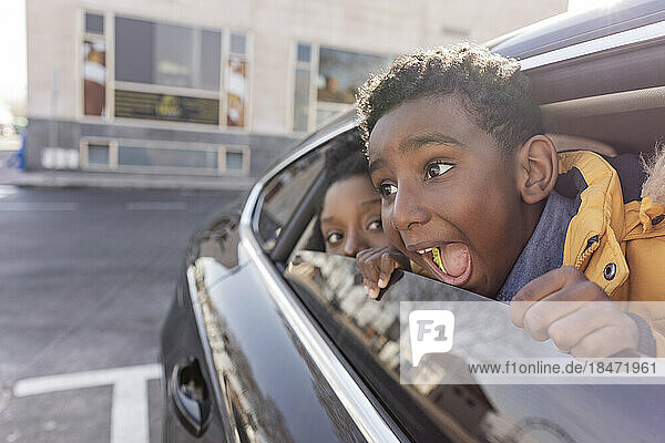 Happy boy with mother shouting in car