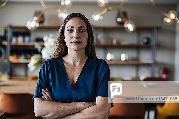 Businesswoman with arms crossed standing in office