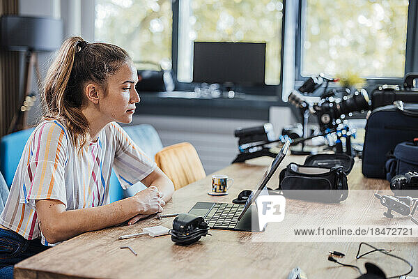 Businesswoman using tablet PC sitting at desk