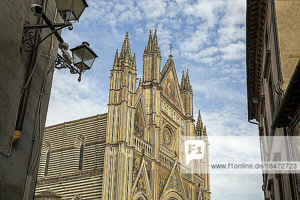 Cathedral of Santa Maria Assunta under cloudy sky  Orvieto  Italy