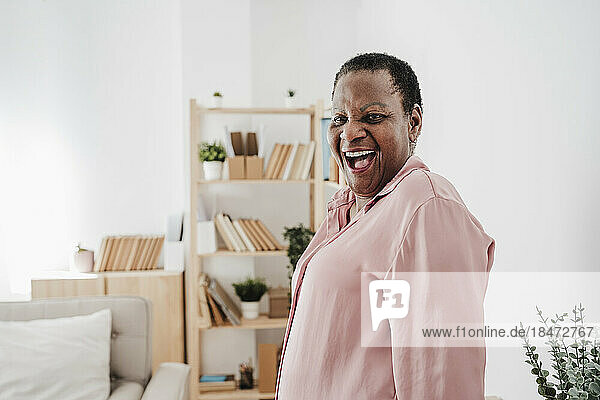 Senior woman laughing at home