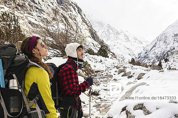 Young couple hiking on snowcapped mountain