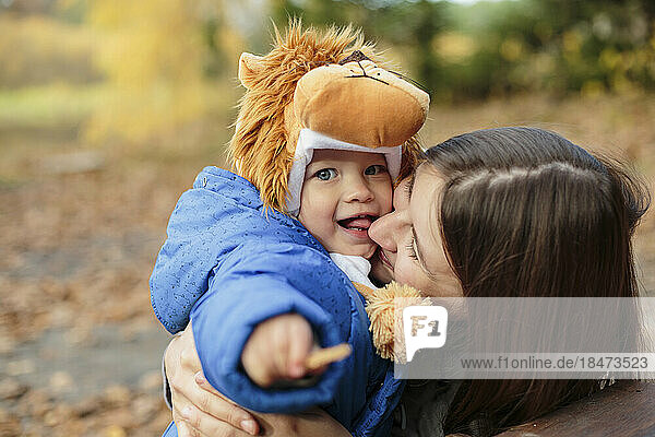 Mother embracing son in park