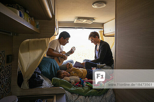 Son enjoying with father and mother in camper van