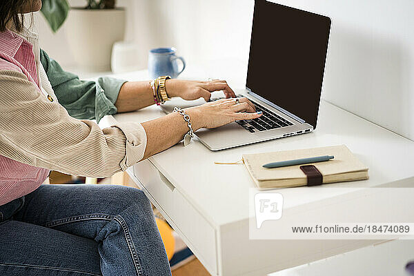 Freelancer working on laptop at home